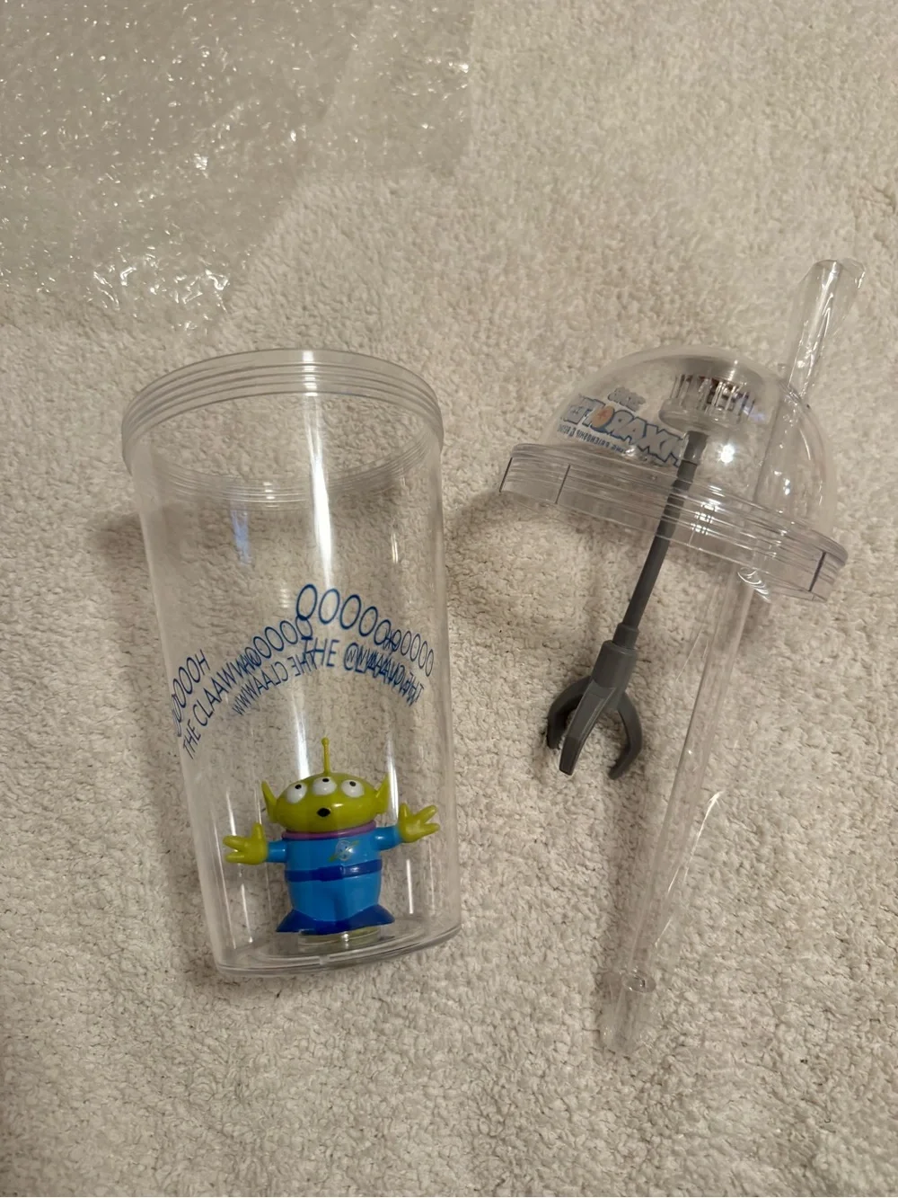 Disney Clear Claw Machine Cup with Green Alien and Blue Outfit